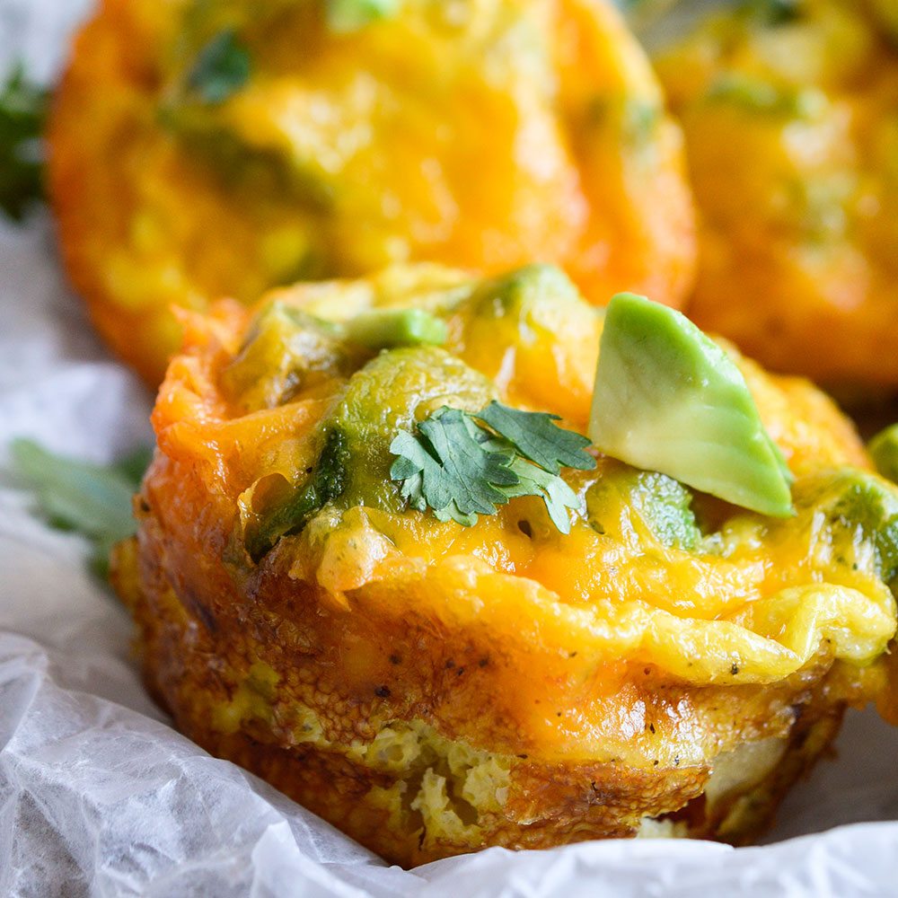 These Cheesy Avocado Egg Muffins are great for feeding a hungry breakfast or brunch crowd! All your favorite breakfast ingredients in one bite sized vegetarian egg muffin.