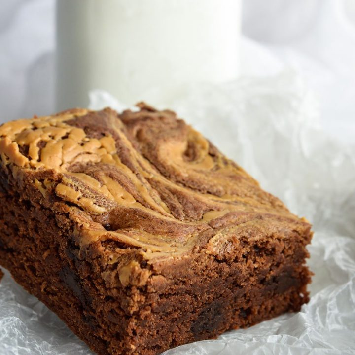 Peanut Butter Brownies with a nice cold glass of milk! This dessert recipe will cure any chocolate and peanut butter craving!