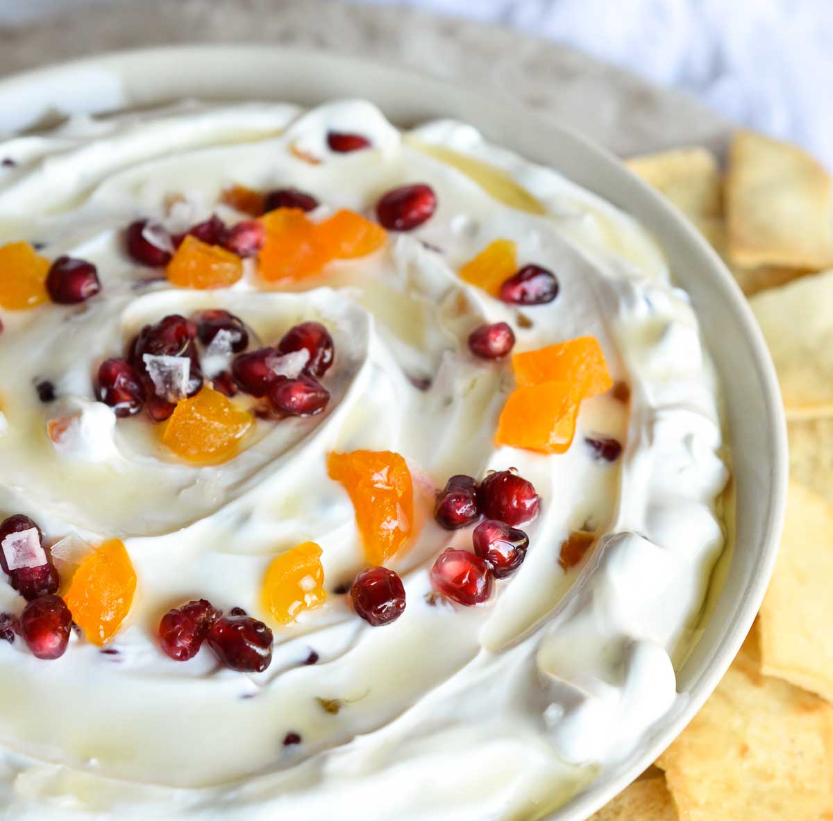Sweet Labneh Cheese Dip is an easy and delicious appetizer or snack. This creamy dip has a Middle Eastern flair with labneh strained yogurt cheese, pomegranate arils, dried apricots and honey!