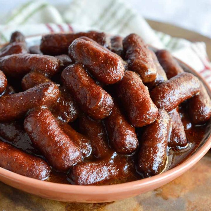 Apple Barbecue Slow Cooker Little Smokies are the perfect holiday appetizer! Mini sausages cooked in your crockpot and slathered with a mild, sweet sauce.