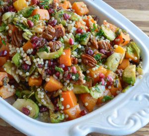 Butternut Squash Pasta Salad is a healthy holiday side dish! This vegan recipe is full of fresh winter produce: butternut squash, brussels sprouts, pomegranate seeds, pecans and pasta. All topped with fresh orange and maple dijon vinaigrette!
