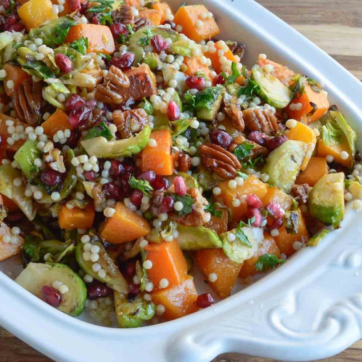 Butternut Squash Pasta Salad is a healthy holiday side dish! This vegan recipe is full of fresh winter produce: butternut squash, brussels sprouts, pomegranate seeds, pecans and pasta. All topped with fresh orange and maple dijon vinaigrette!