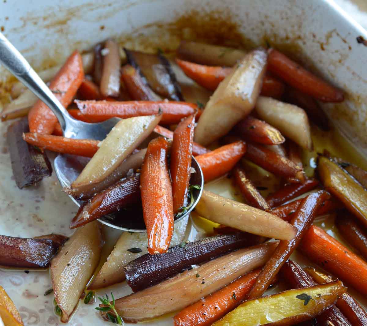 Enjoy your favorite holiday side dish without the guilt. These Healthy Candied Carrots are roasted with olive oil, maple syrup and thyme. Sweet and salty roasted carrots will be a new family favorite!
