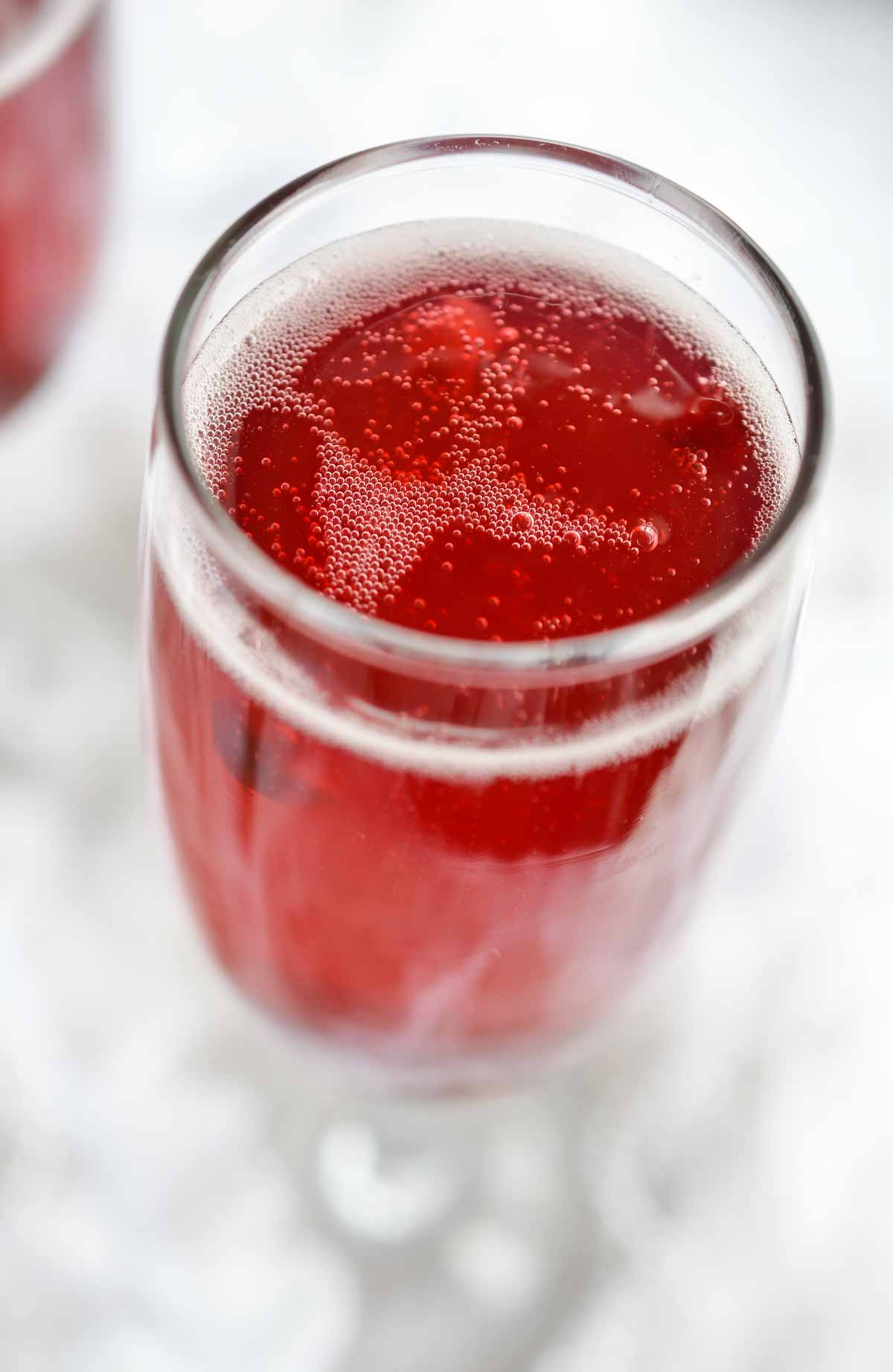 This Pomegranate Mimosa Recipe is perfect for New Year's Eve or brunch. A simple blend of champagne and pomegranate juice for a bubbly festive drink! Cheers!