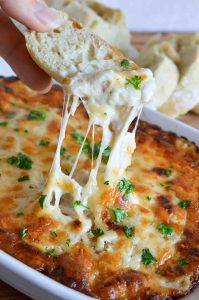 This Hot Cheesy Onion Dip Recipe is perfect for parties, holidays or game day! Melted cheese and caramelized onions in a creamy obey-gooey dip. The best appetizer EVER!