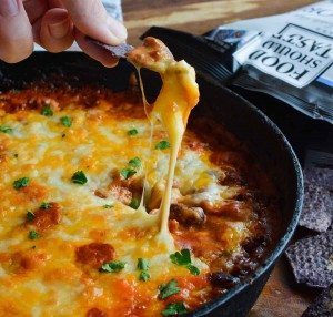 Easy Cheesy Chili Dip is the ultimate appetizer! Make this Homemade Chili Cheese Dip Recipe for parties, holidays or game day.