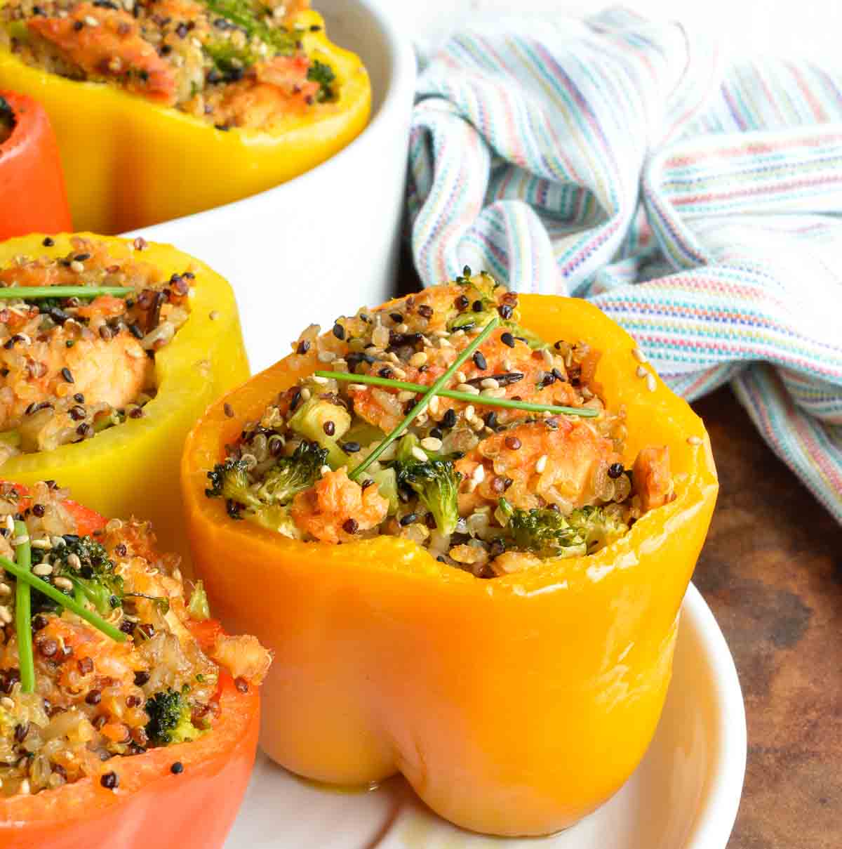 This dinner recipe is healthy, flavorful and satisfying. Salmon and Quinoa Stuffed Peppers make a nutritious meal! Sweet bell peppers stuffed with salmon, brown rice, quinoa, broccoli and a spicy Asian sauce.