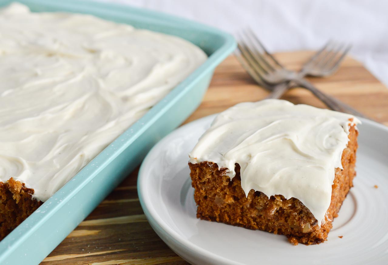 This Easy Apple Cake Recipe is the perfect dessert for feeding a crowd. This apple sheet cake is made with apple pie filling and topped with a luscious vanilla cream cheese frosting. Perfect for holidays, parties, potlucks or brunch!
