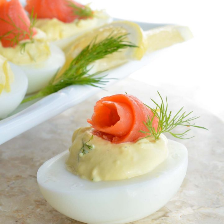 This Smoked Salmon Deviled Eggs Recipe is the best way to use those leftover Easter eggs! Creamy deviled eggs topped with smoked salmon, dill and lemon. These are perfect for any brunch or holiday feast!