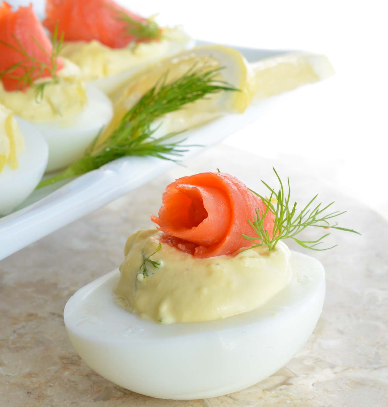 This Smoked Salmon Deviled Eggs Recipe is the best way to use those leftover Easter eggs! Creamy deviled eggs topped with smoked salmon, dill and lemon. These are perfect for any brunch or holiday feast!