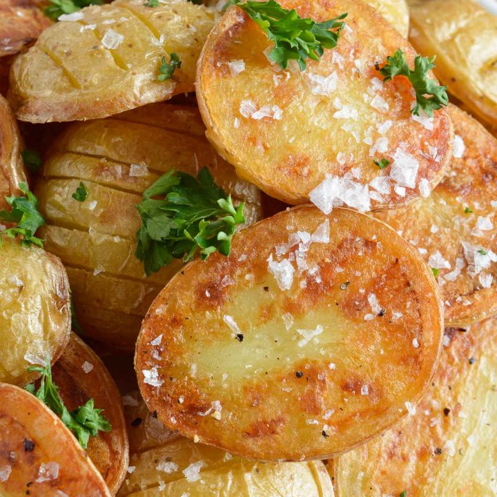 These Simple Oven Roasted Potatoes are absolute potato perfection! Golden brown and crispy on one side, creamy and dreamy on the other. This recipe is great as a side dish for just about any meal!