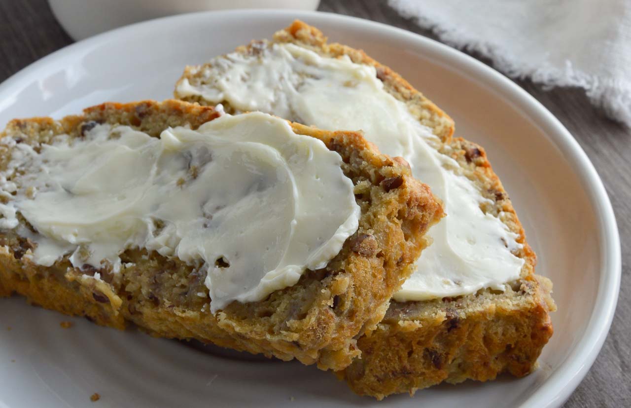 Say goodbye to dry, hard to swallow chunks of banana bread. This Super Moist Banana Bread Recipe is made with Greek yogurt and roasted bananas. This flavorful quick bread is perfect for dessert, breakfast or a snack!