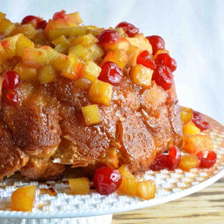 This Pineapple Upside Down Monkey Bread Recipe is just one of the fantastic dishes in the new Chew Cookbook! Pull-apart monkey bread topped with caramel, pineapple and cherries. The perfect dessert to share with a crowd!