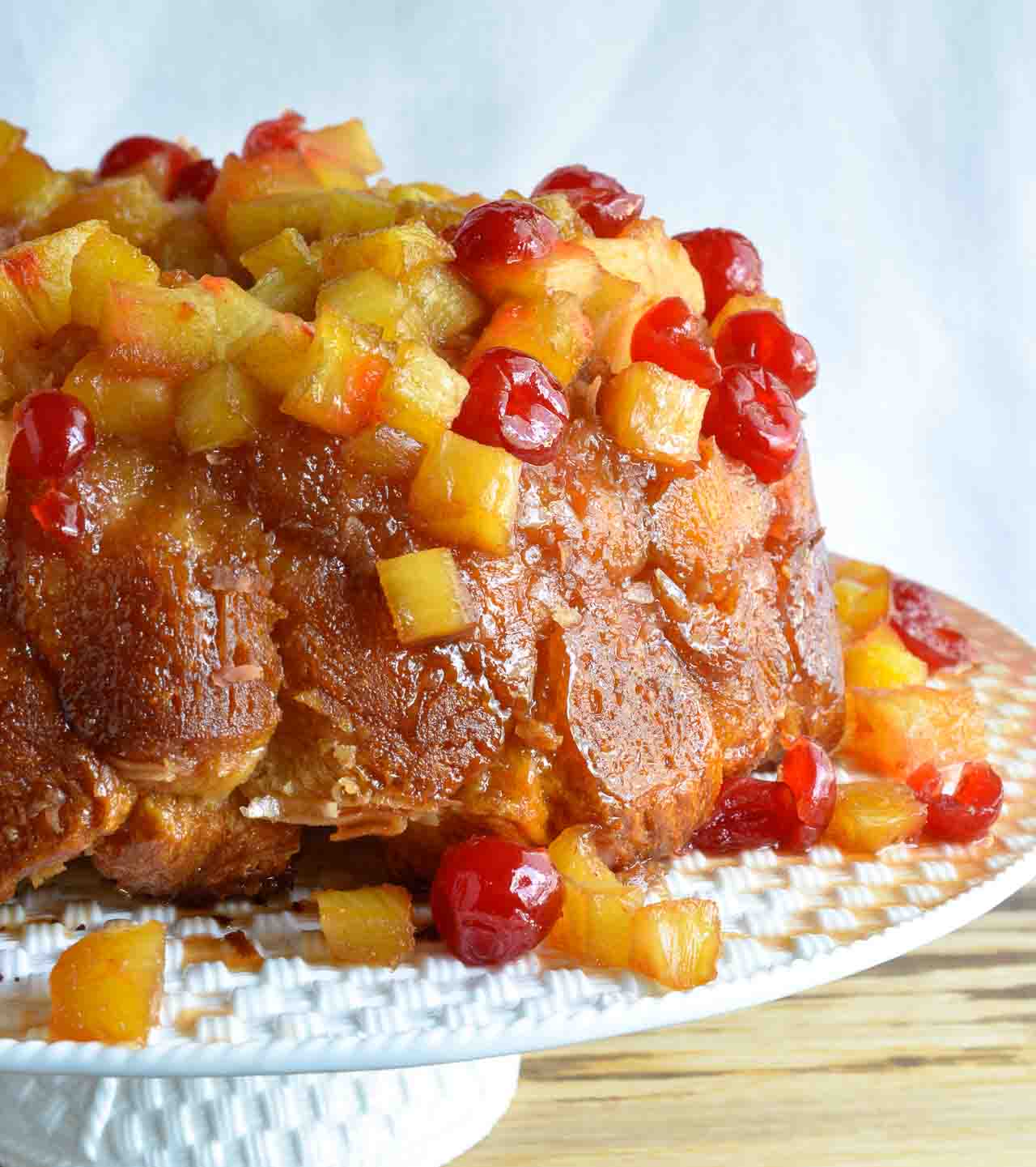 This Pineapple Upside Down Monkey Bread Recipe is just one of the fantastic dishes in the new Chew Cookbook! Pull-apart monkey bread topped with caramel, pineapple and cherries. The perfect dessert to share with a crowd!
