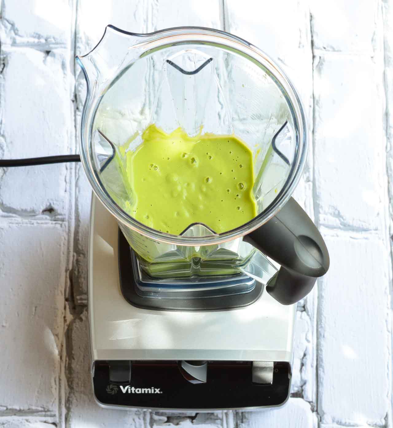 Make this Easy Pea Soup Recipe with frozen peas right in your blender! This soup is bursting with bright lemon flavor and topped with cool crème fraîche. Hot or cold, this soup makes a great lunch or dinner in 15 minutes or less!