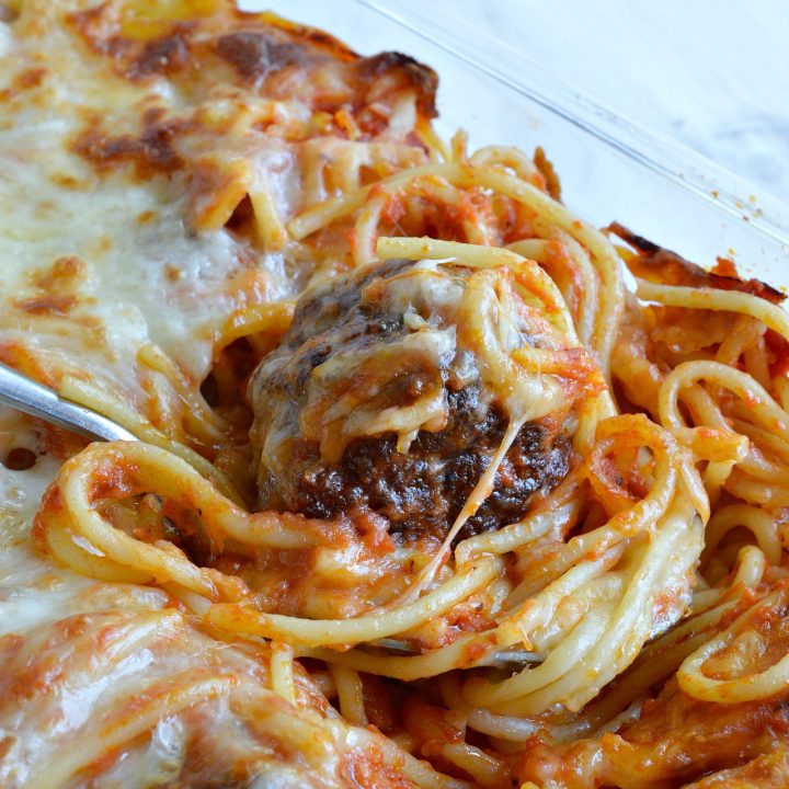 Cheesy Baked Spaghetti and Meatballs is a new fun way to serve this family favorite comfort food! Add this dinner recipe to your menu for spaghetti with a twist. A simple casserole made with layers of pasta, marinara sauce, cheese and meatballs.