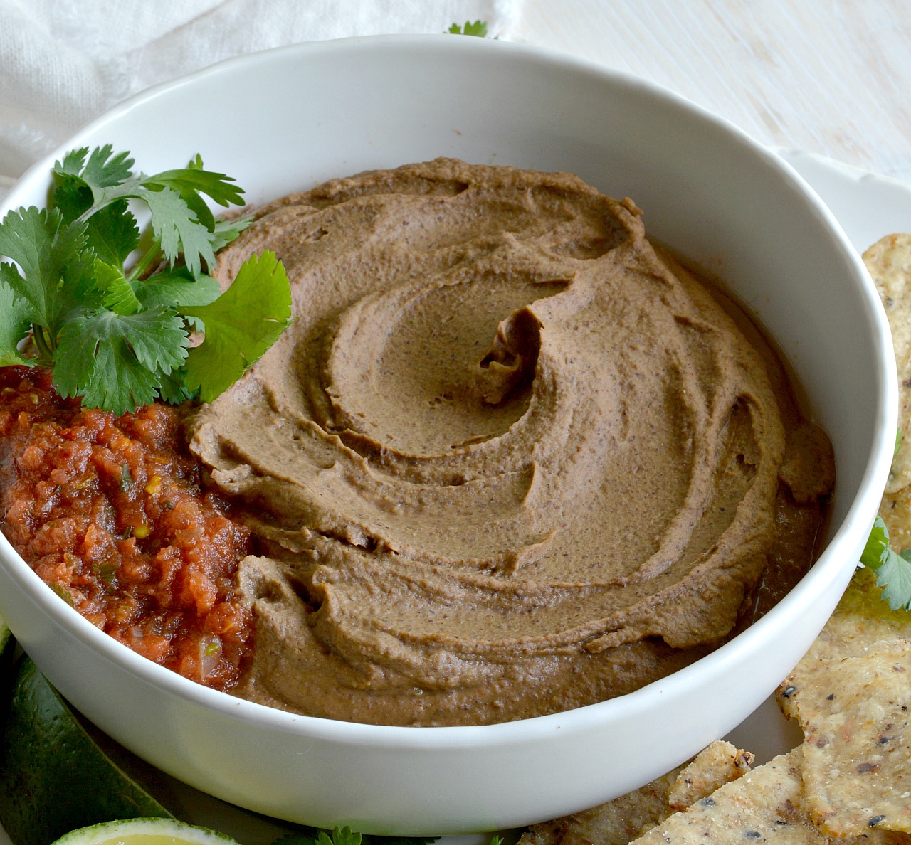If you are looking for a new twist on boring old bean dip, try this Chipotle Black Bean Dip Recipe! Black beans, chipotle, adobo and lime blended to make this fantastic homemade cold dip. The perfect summertime snack!