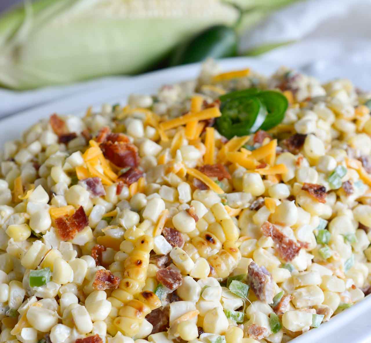 Bring on Summer and Barbecue season! This Jalapeño Popper Grilled Corn Salad Recipe brings so many great flavors together in one amazing side dish! Fresh grilled corn, bacon, jalapeño and cheddar cheese in a creamy summer salad.