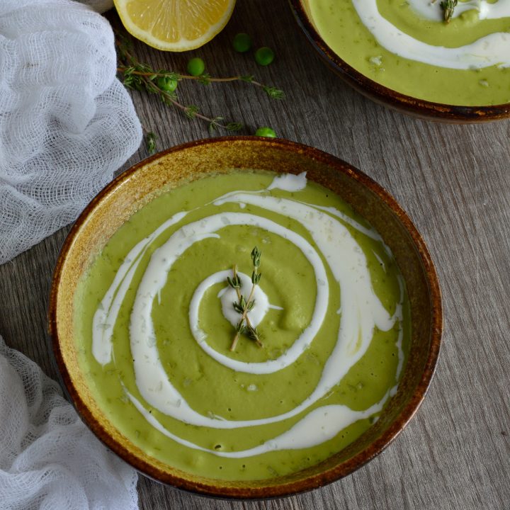 Make this Easy Pea Soup Recipe with frozen peas right in your blender! This soup is bursting with bright lemon flavor and topped with cool crème fraîche. Hot or cold, this soup makes a great vegetarian lunch or dinner in 15 minutes or less!