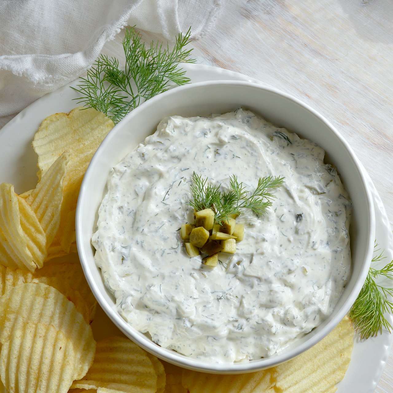 You NEED to try this Dill Pickle Dip recipe! Forget about french onion dip. This dip appetizer will be a new crowd favorite! This creamy dip is full of fresh dill and tangy pickles. Look Out! You may eat the entire bowlful!
