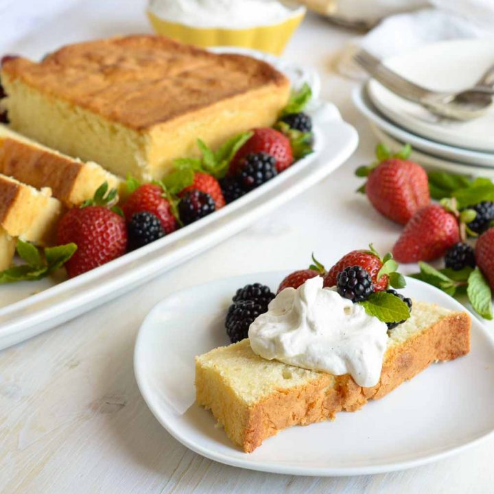 Make this Amaretto Pound Cake Recipe with Whipped Mascarpone for a simple and indulgent dessert. This easy homemade cake is flavored with almond and amaretto then baked in a loaf pan. Serve with fluffy whipped vanilla mascarpone cheese and fresh berries for a gorgeous sweet treat!
