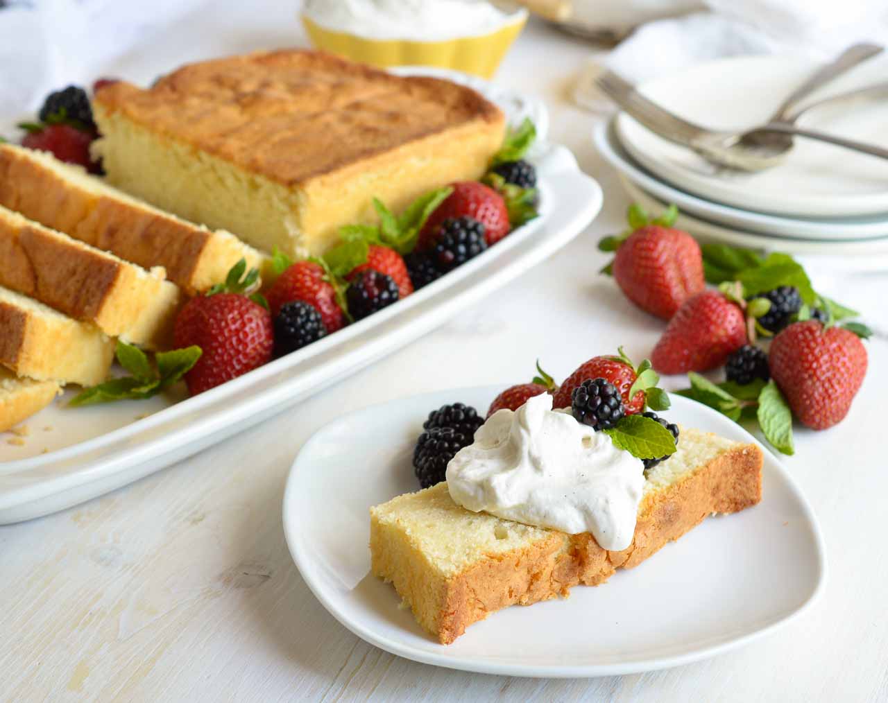 Make this Amaretto Pound Cake Recipe with Whipped Mascarpone for a simple and indulgent dessert. This easy homemade cake is flavored with almond and amaretto then baked in a loaf pan. Serve with fluffy whipped vanilla mascarpone cheese and fresh berries for a gorgeous sweet treat!
