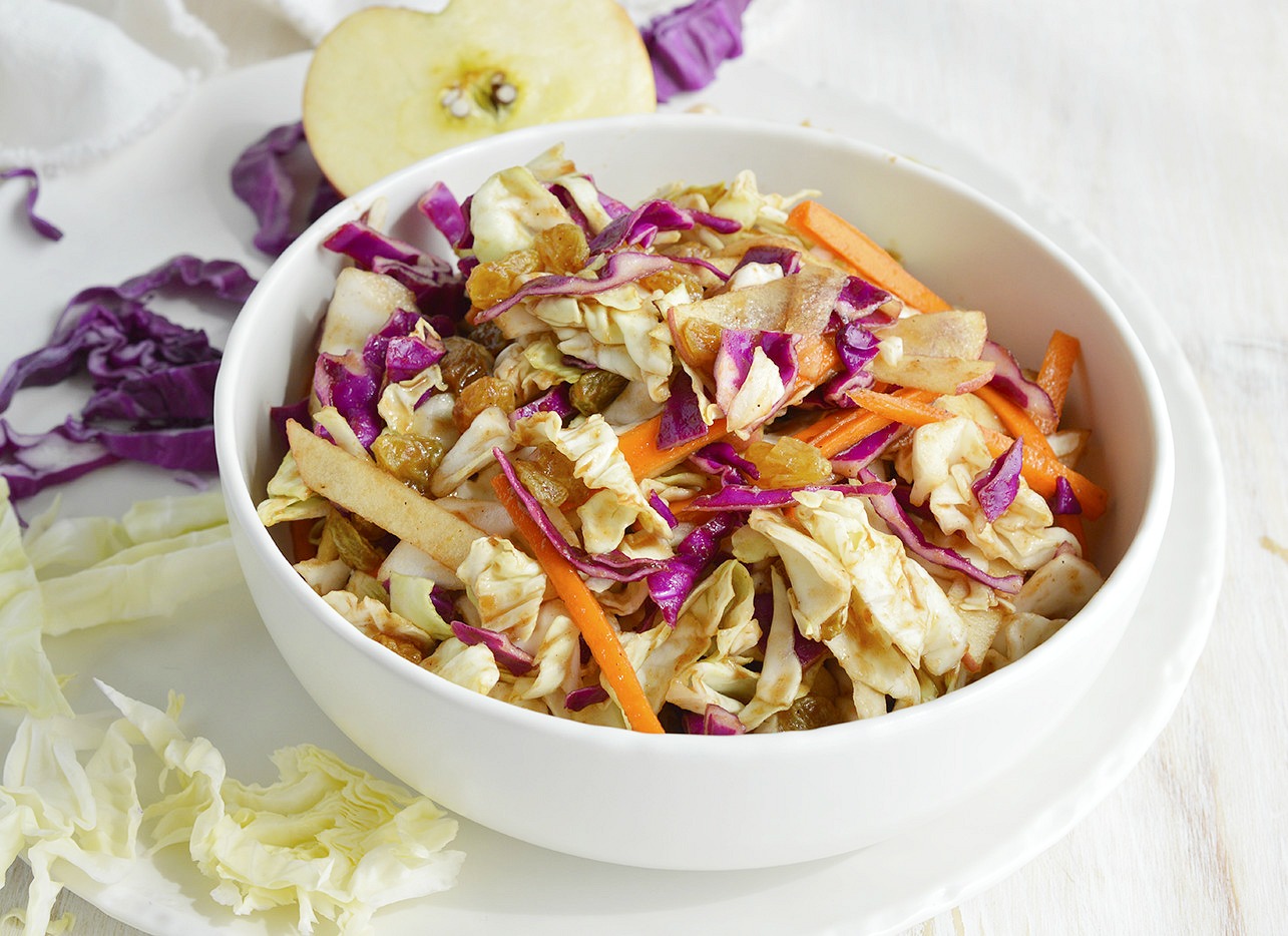 Try a unique twist on your favorite barbecue side dish. Instead of plain coleslaw make this Sweet and Savory Cabbage Apple Slaw! Red and green cabbage, carrots, apples, golden raisins tossed with a tangy apple vinegar dressing.