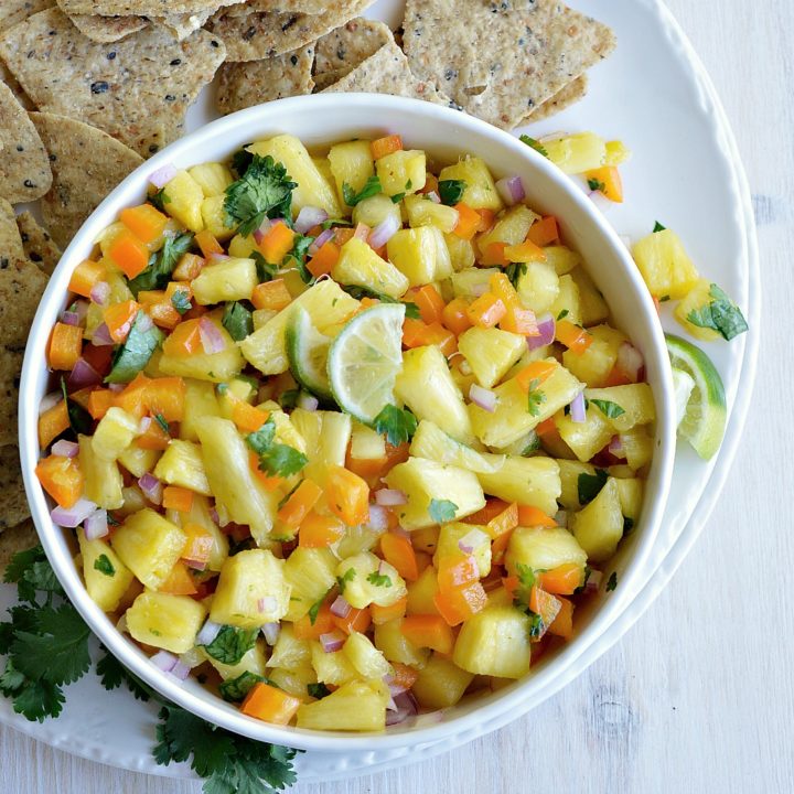 If you want a fresh and fruity summer snack, make this Pineapple Salsa Recipe! It just takes a few simple ingredients and about 5 minutes to make this tasty appetizer. Perfect for summertime parties and backyard barbecues!