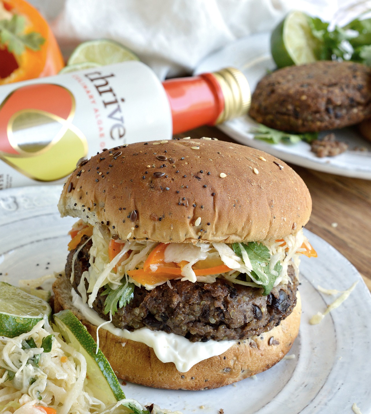 This Cheese Stuffed Quinoa Black Bean Burger with Cilantro Lime Slaw is so tasty you will not even miss the meat! Veggie burgers can be easy and delicious with this recipe. And the cilantro lime coleslaw is amazing! This is one vegetarian meal that everyone can enjoy. Eat burgers on Meatless Monday!