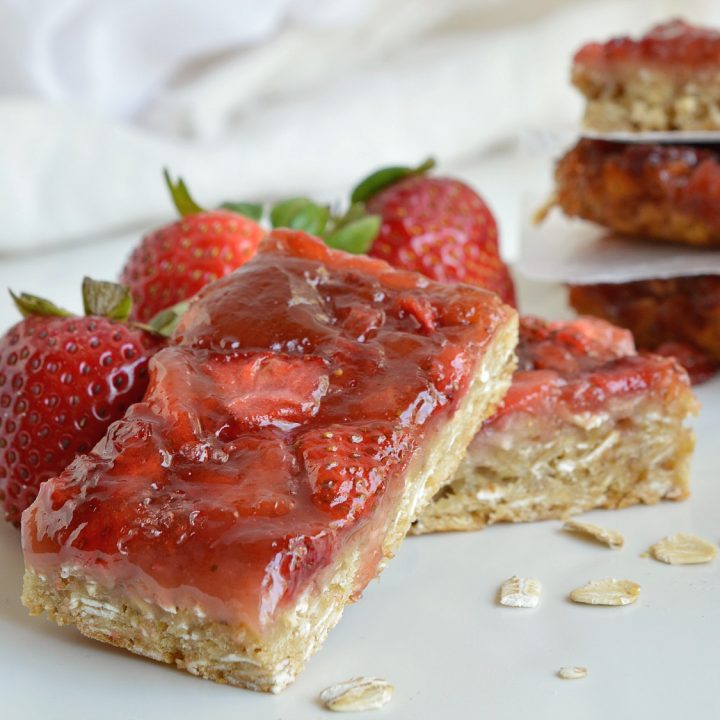 You don't have to be vegan to enjoy these Strawberry Oatmeal Vegan Breakfast Bars. The chewy oatmeal bars topped with fresh strawberries and jam are a nutritious way to start your day! This also makes a great healthy snack or breakfast on the go! A great vegan recipe that everyone will love!