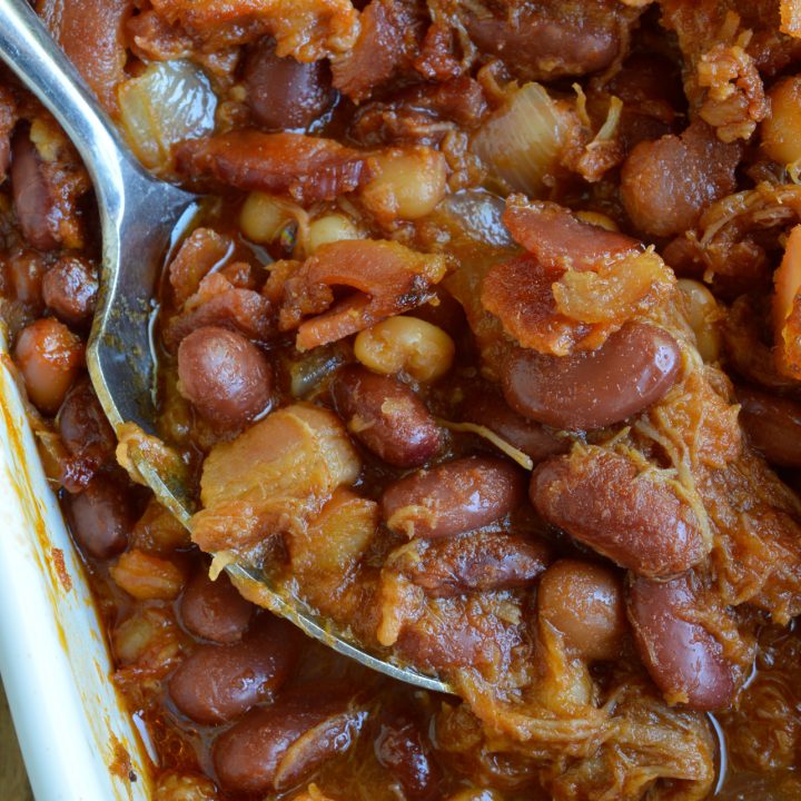 The pulled pork and bacon in this Double Pork Baked Beans Recipe makes it perfect as a side dish or dinner! Homemade pork and beans is super easy and delicious. This dish is great for feeding a hungry crowd!