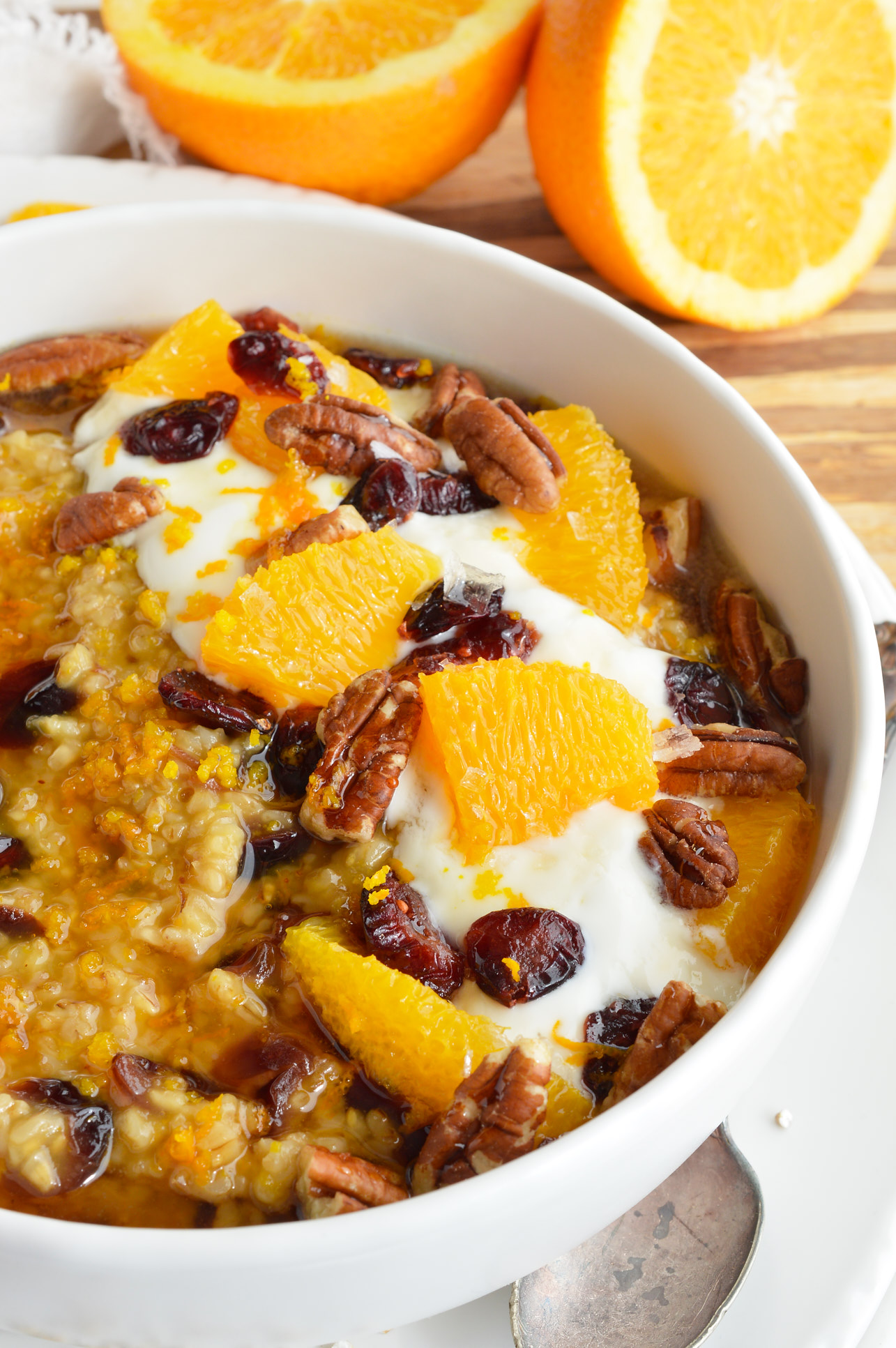 This Cranberry Orange Steel Cut Oats Recipe is a quick, easy, gluten free and healthy homemade breakfast. Stovetop oatmeal flavored with fresh squeezed orange juice and dried cranberries. What a great way to start your morning, especially when it is cold outside!