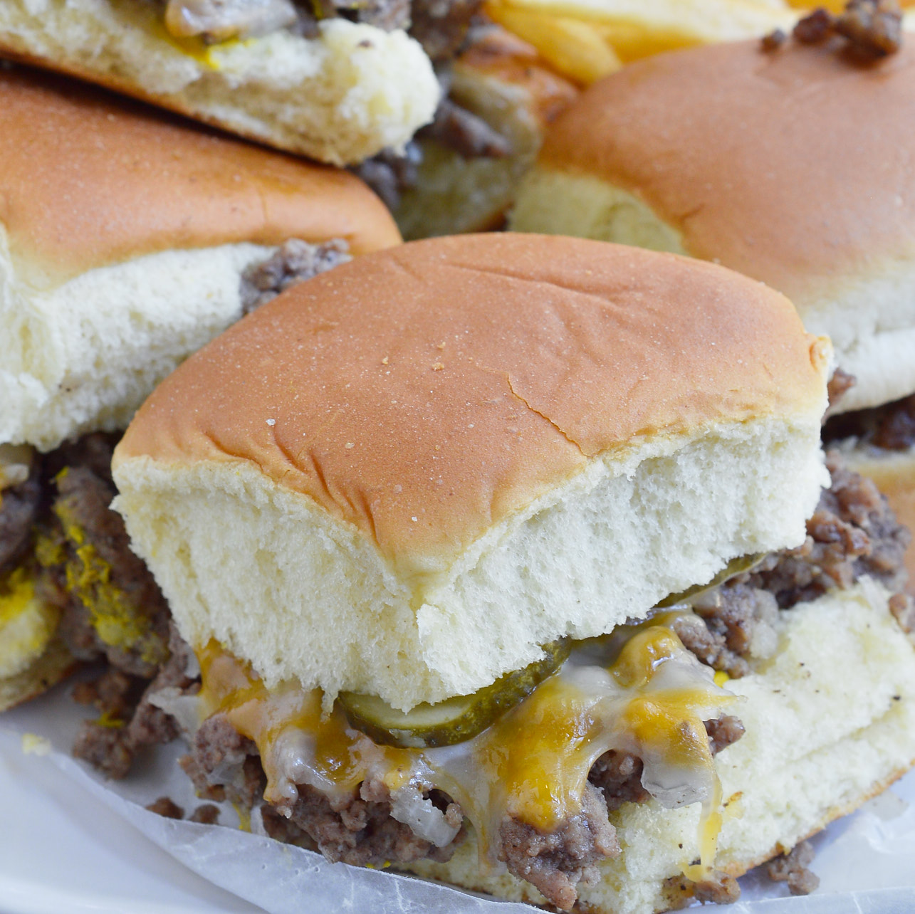 These Oven Baked Mini Burgers are inspired by my favorite fast food, White Castle and Krystal Burgers. This copycat recipe of my ultimate craving is perfect for feeding the family or a large crowd on game day! Don't forget the fries and sweet tea!