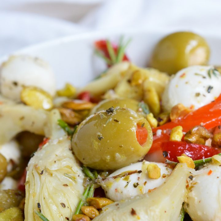 For a quick and easy appetizer, make these Marinated Mozzarella Balls, Artichokes and Olives. This appetizer recipe is full of garlic and fresh herb flavor. Perfect for serving at holiday feasts and parties!