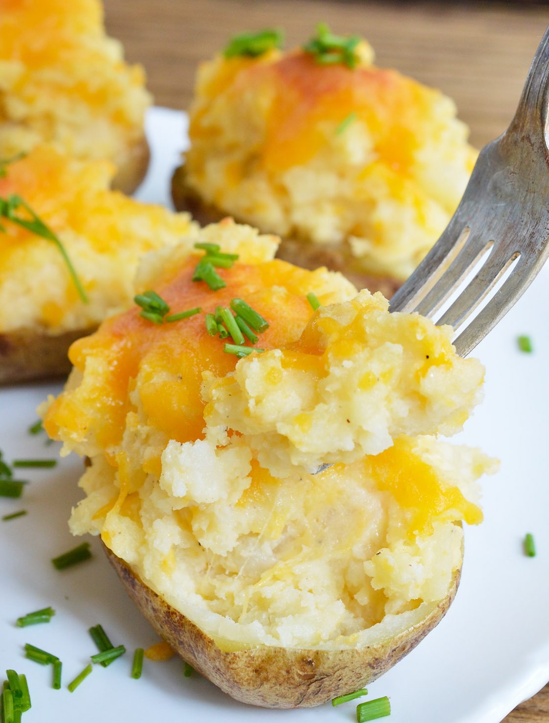 These Easy Cheesy Twice Baked Potatoes make the perfect holiday side dish! Learn a little trick that takes this stuffed potato recipe to the next level. This method makes the potato skins super delicious!