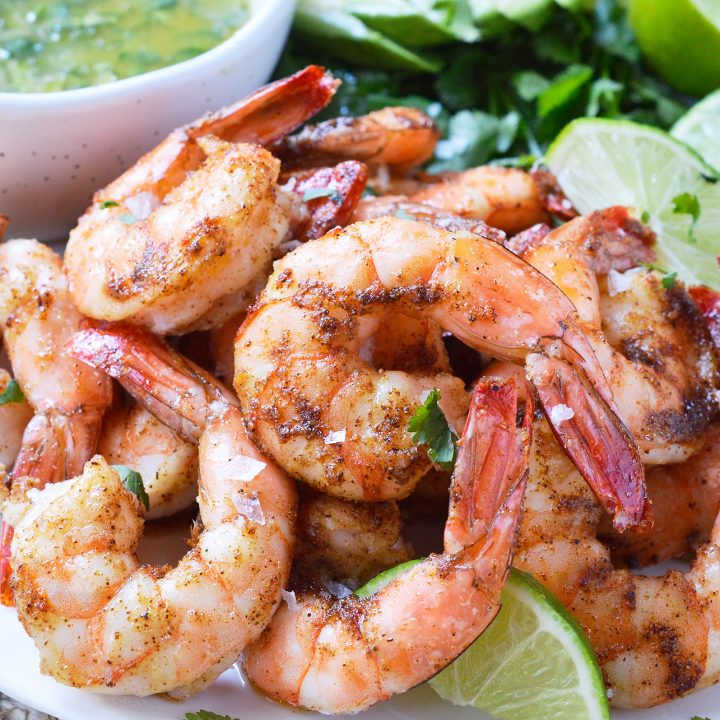 For punch in the face flavor, make these Cilantro Lime Spicy Baked Shrimp! This Whole30 compliant recipe starts with shrimp covered in spices, baked to perfection then served with a fresh cilantro lime dip. Perfect for a healthy lunch, dinner, appetizer or a snack!