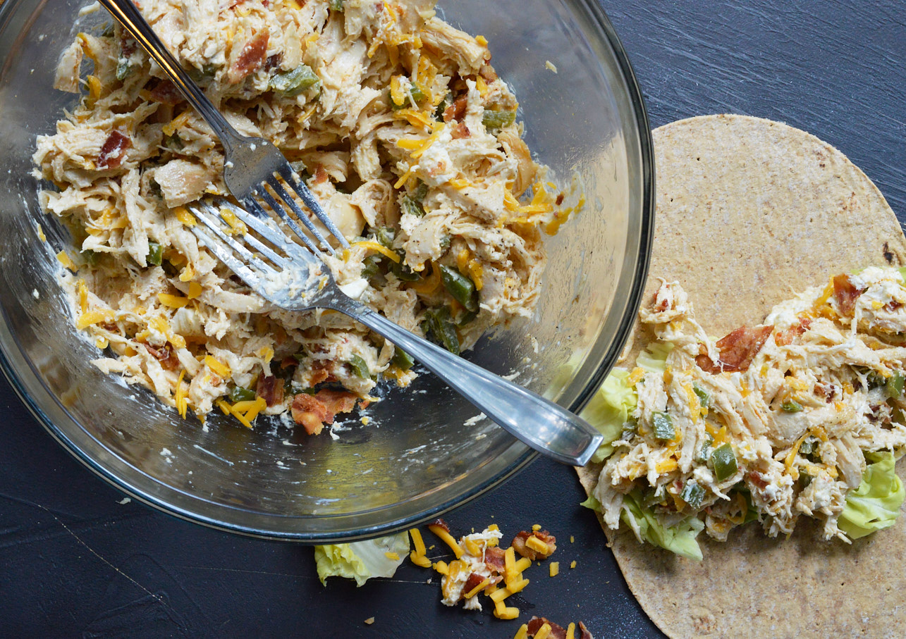 This Jalapeño Popper Chicken Salad is the ultimate! Creamy chicken salad with roasted jalapeños, bacon and cheddar cheese. Say goodbye to boring ol' chicken sandwiches and have Jalapeño Popper Chicken Wraps instead.