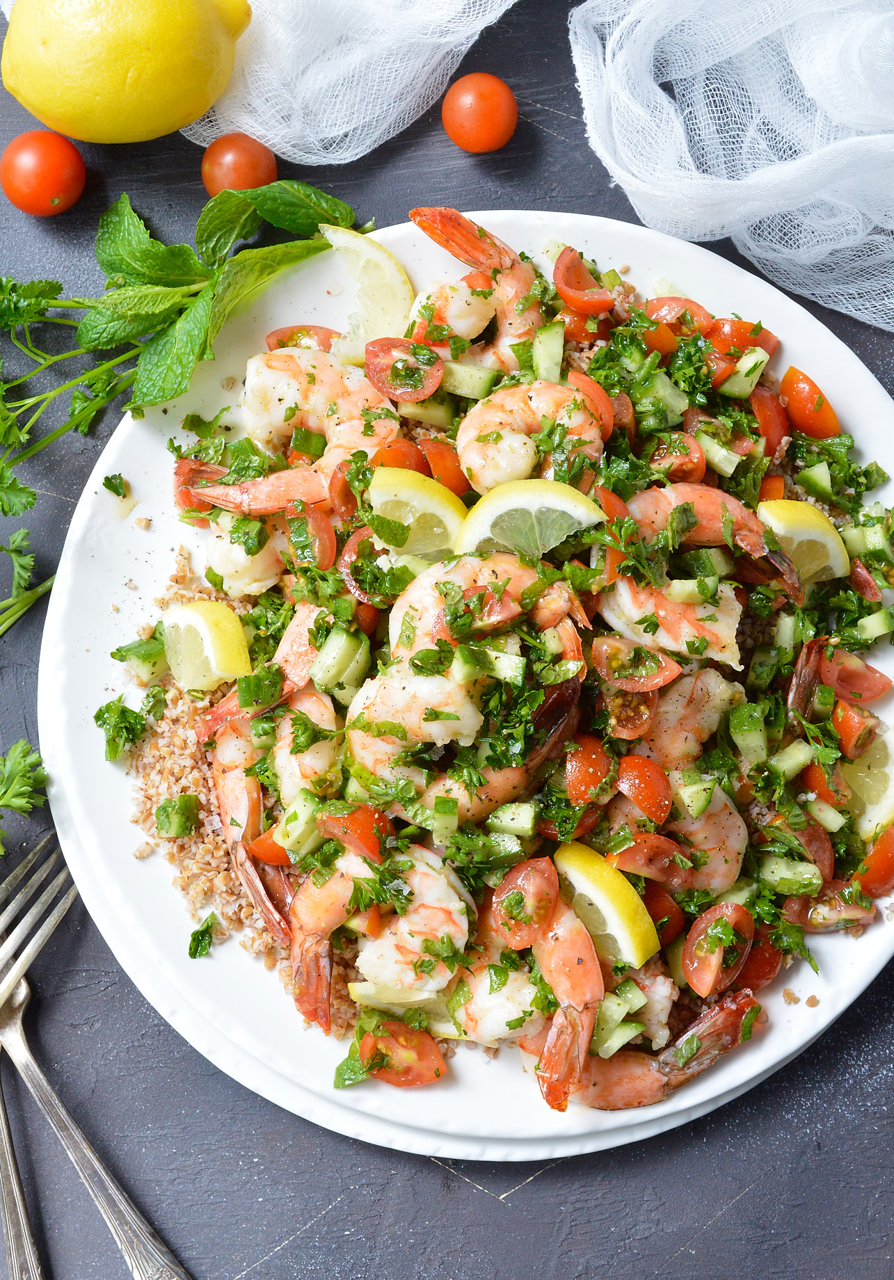 Looking for a healthy, nutritious meal with tons of flavor? This Tabouli Shrimp Salad Recipe has it all! Made with the traditional tabbouleh ingredients of mint, parsley, lemon, tomatoes, cucumber and lemon. The addition of shrimp makes this a satisfying meal that is great for lunch or dinner.