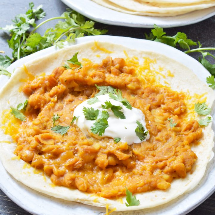 If you make this Refried Beans Recipe with Canary Beans you may never go back to the canned variety! This refried beans recipe is simple and produces the creamiest consistency thanks to the Canary Beans, also known as Mayocoba beans. These Peruvian beans are similar to pinto beans and taste great with any of your favorite Mexican dishes! vegetarian and vegan options included