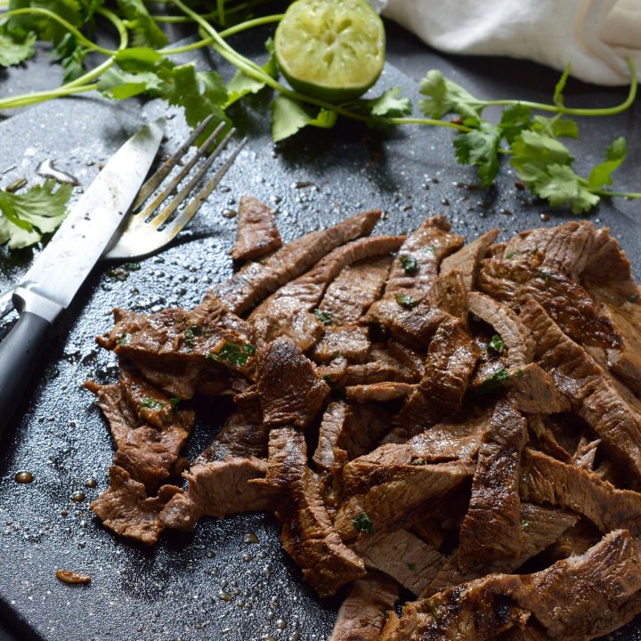 Nothing beats a great Carne Asada Recipe for the summertime grill season! This Carne Asada is made with thinly sliced round tip steak marinated in orange, lime, cilantro and garlic. Perfect for wraps, tacos, burrito bowls or any Mexican food dish you can think of!