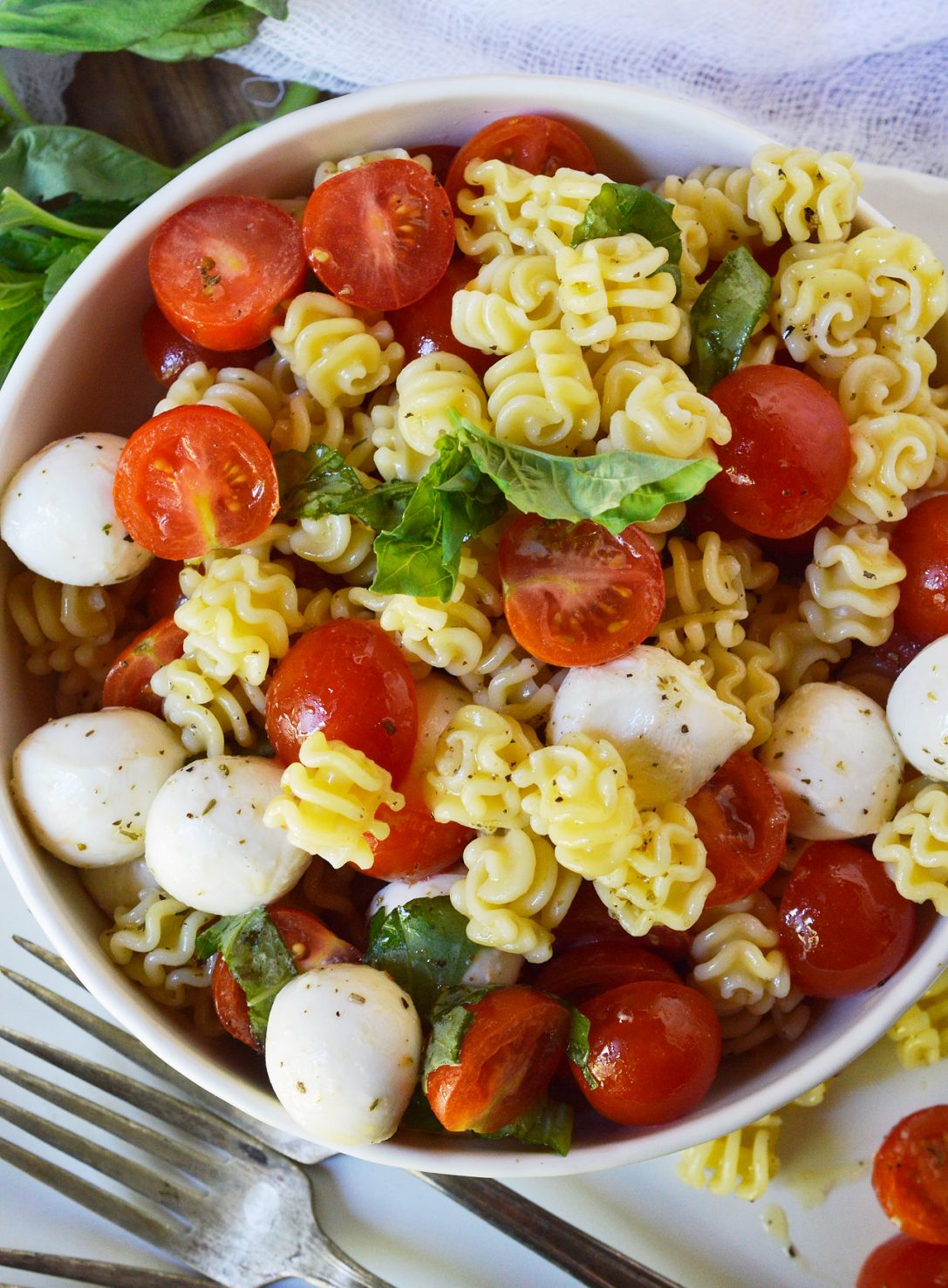 Caprese Pasta Salad Recipe is a simple yet flavorful side dish. This pasta salad is filled with mozzarella, tomatoes and basil. Tossed with an Italian oil dressing and topped with balsamic glaze.