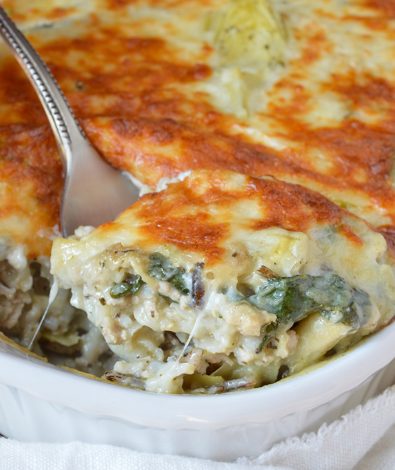spoon scooping casserole
