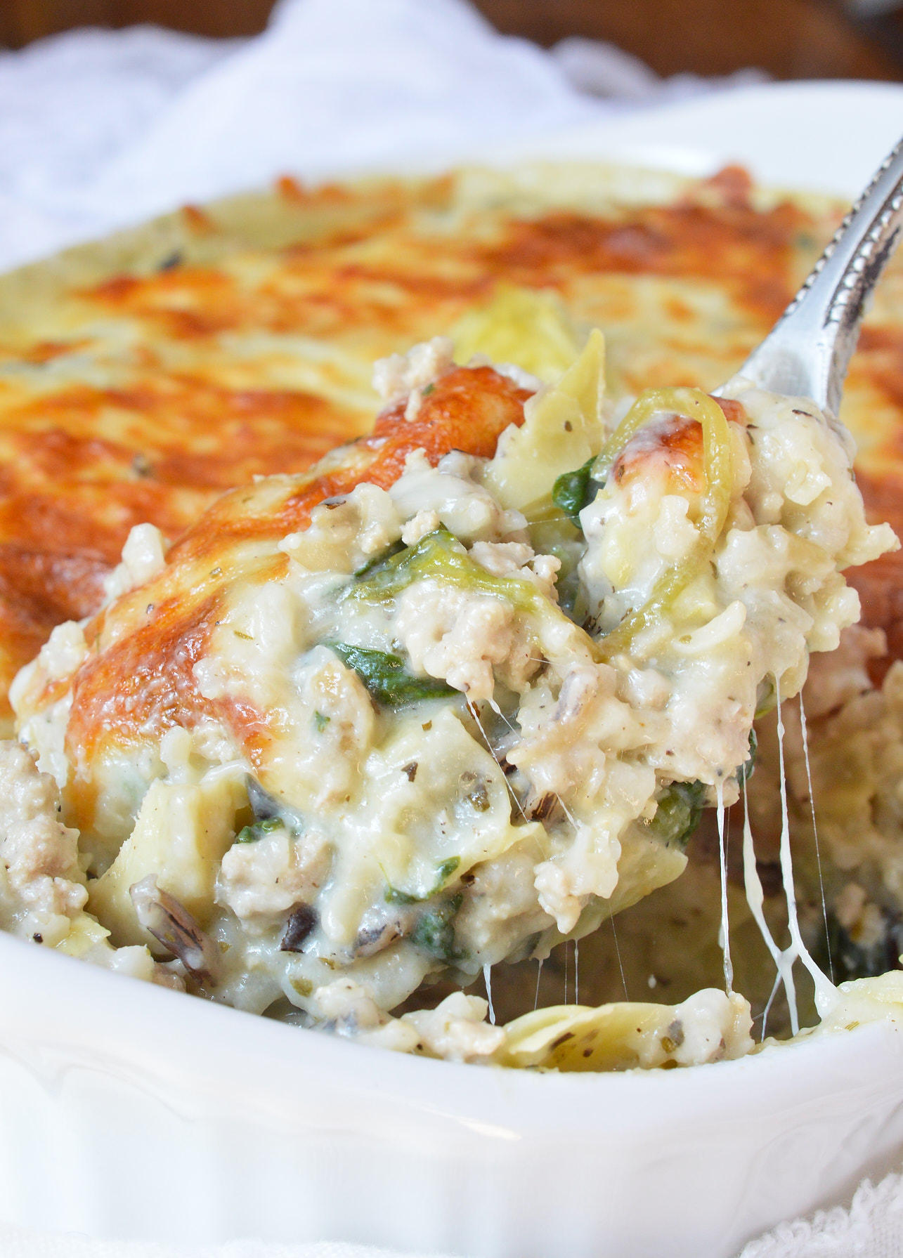 serving spoon scooping casserole