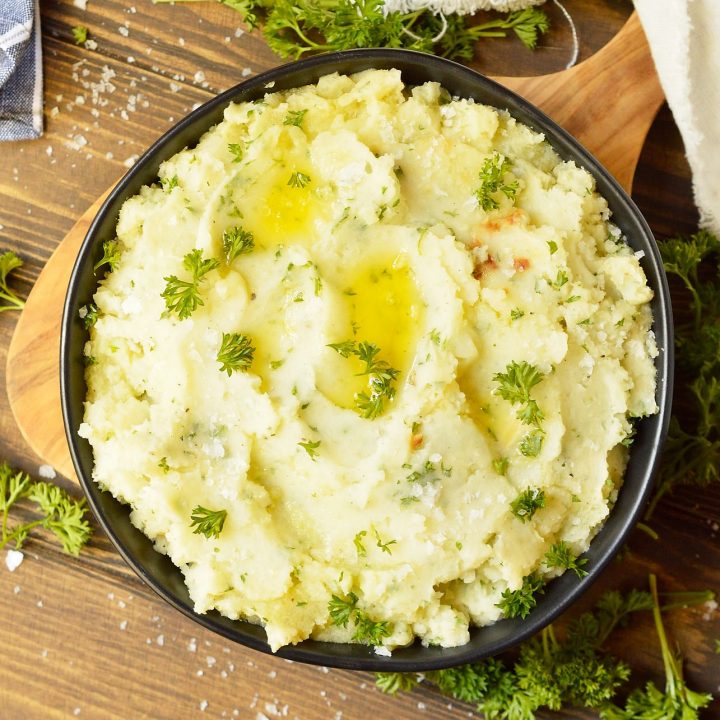 mashed potatoes topped with parsley in black bowl