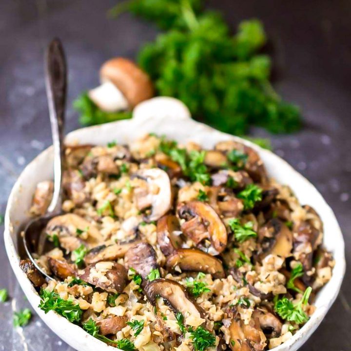 mushroom cauliflower rice in white bowl with spoon