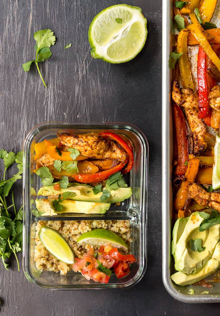 glass meal prep container filled with chicken fajitas ingredients, cauliflower rice and limes