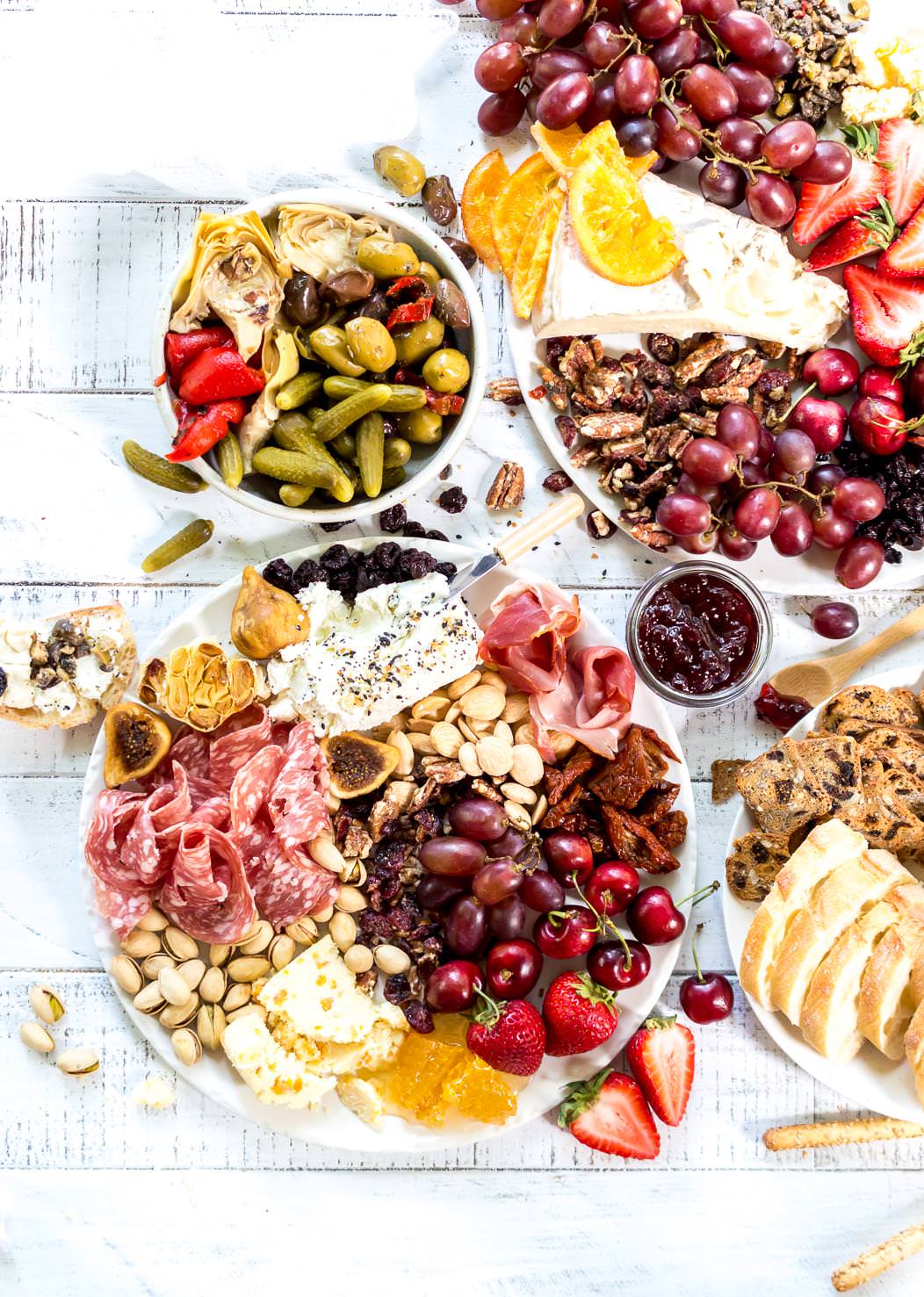 Throw an EPIC Summer Party without even turning your oven on! This Charcuterie Board and Orange 75 Cocktails are perfect for entertaining. The cheese platter is is loaded with meats, cheeses, crackers, fruits, nuts and more. And this simple cocktail recipe is sure to impress your guests! #entertaining #partyideas #cheeseboard #cocktailrecipes