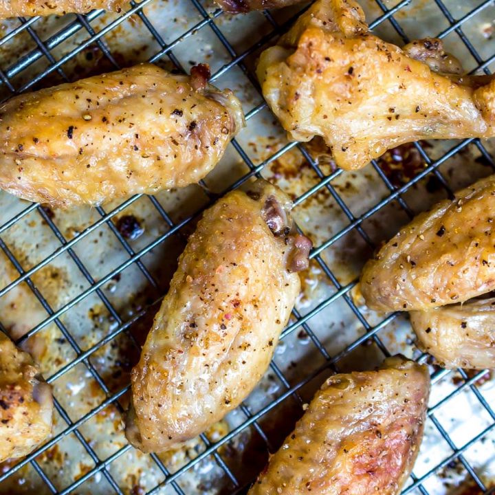 chicken wings on rack over baking sheet