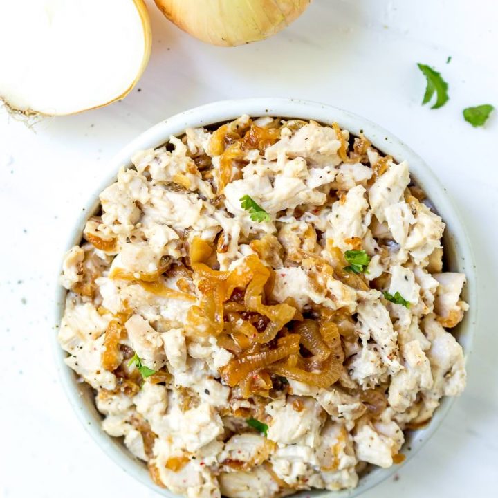 overhead photo of white bowl filled with caramelized onion paleo chicken salad