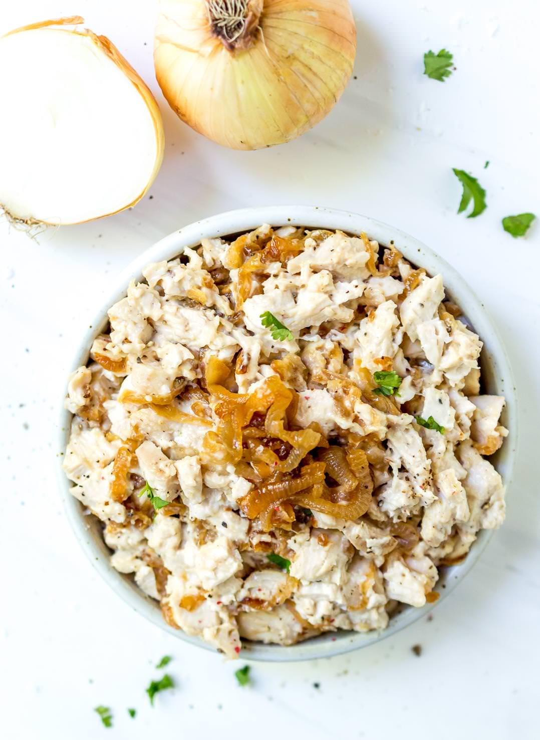 overhead photo of white bowl filled with caramelized onion paleo chicken salad 